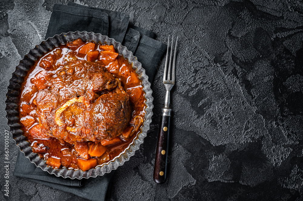 Braised meat on the bone Osso Buco in tomato sauce, veal italian meat
