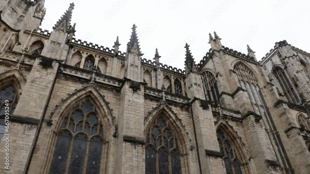 Slow panning shot of the beautiful York Minster Cathedral with cloudy conditions Slow panning shot of the beautiful York Minster Cathedral with cloudy conditions
