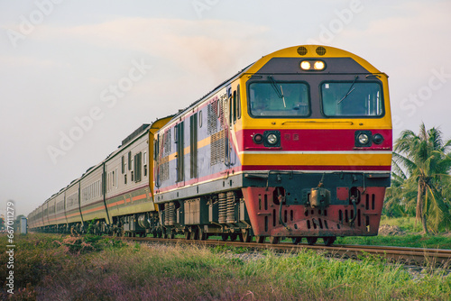 Passenger train by diesel locomotive on the railway.