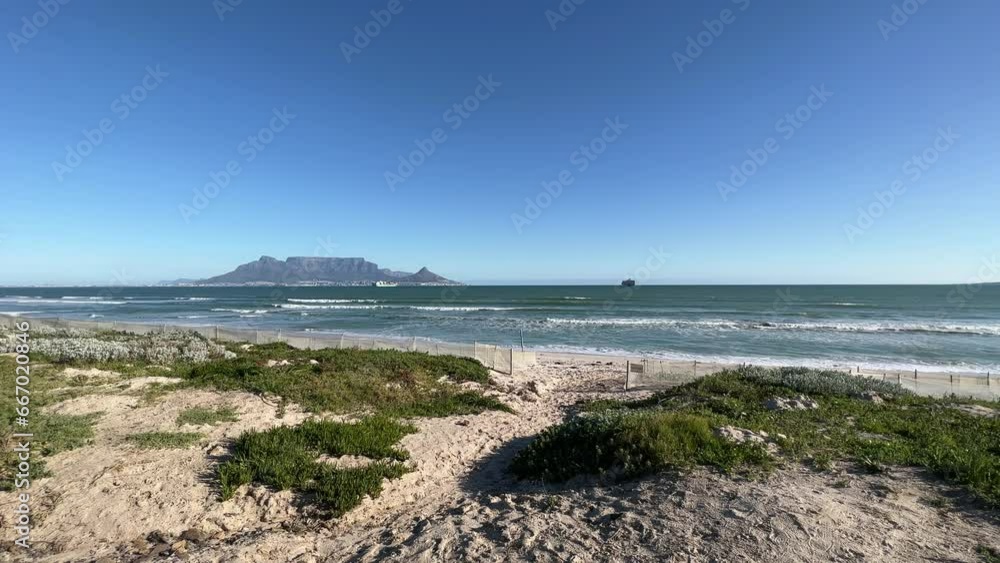 Table Mountain on the horizon with ships in Table Bay from the beach Table Mountain on the horizon with ships in Table Bay from the beach
