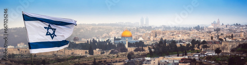Jerusalem panorama with waving flag of Israel over the old walls of holy land. Cityscape of Jerusalem - sacred place of three world religions - Christians, Muslims and Jews. © Repina Valeriya