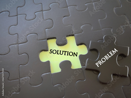 Motivational and inspirational wording. Problem solving concept. PROBLEM and SOLUTION written on puzzle pieces. With blurred styled background.