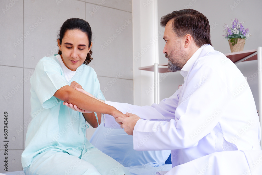 Fototapeta premium Doctor with patient lying on bed in exam room.