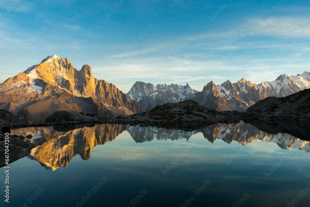 Silhouette of Man, Mountains and Reflection in Lac Blanc Lake at Sunset. Golden Hour. Chamonix, French Alps, France