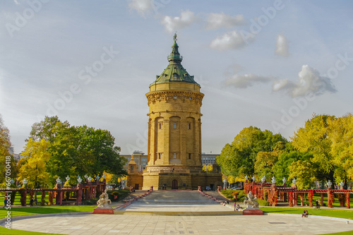 Mannheim, Germany. Panoramic view over old city water tower at Friedrich square in sunset golden Autumn colors. Cityscape in the historical downtown at sunny day and milky blue sky.