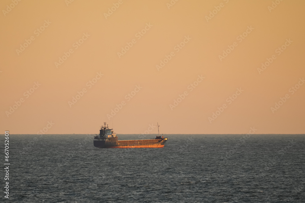 Fototapeta premium Oil tank in the open Baltic sea at dawn.