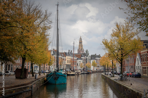 Groningen, the capital of the province of Groningen, with the many beautiful canals and houseboats, and in the background the famous Martini tower.