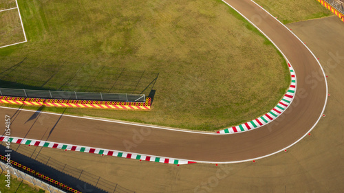 Aerial view of a curve of a racing circuit. The track is empty and there are no cars racing.