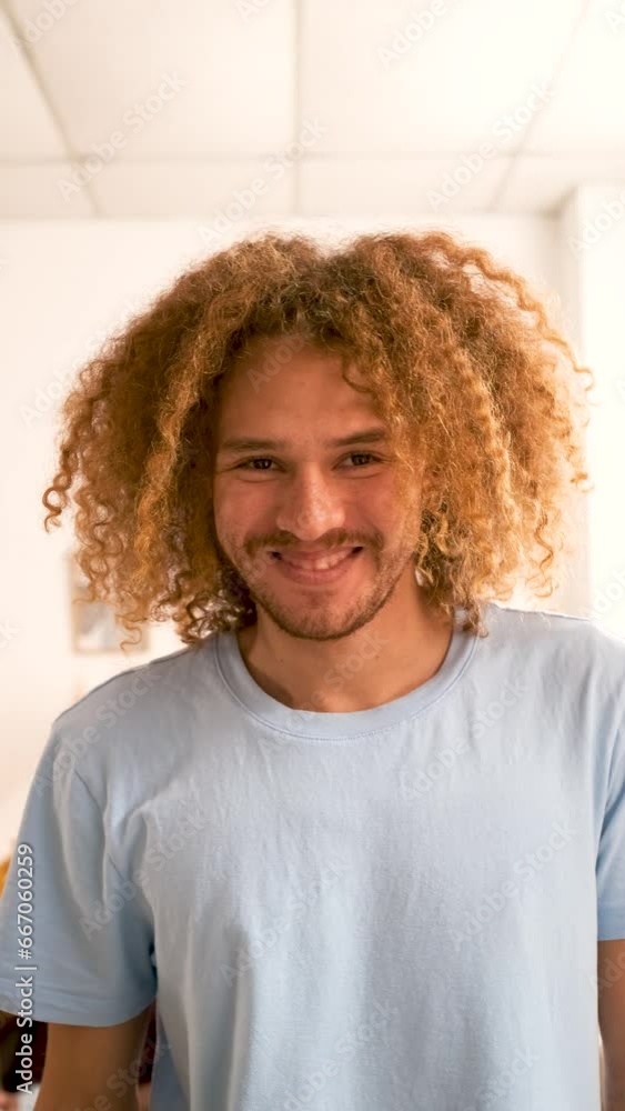 Portrait of young Latin man looking at camera and smiling at home. Portrait of young Latin man looking at camera and smiling at home.