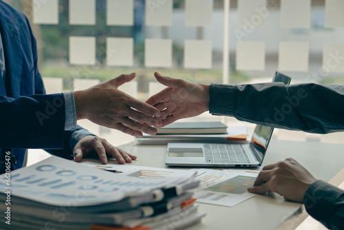 Businessmen join hands for teamwork in business mergers and acquisitions, successful negotiations, with partners celebrating partnership. Close-up pictures