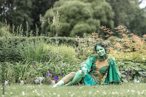 фотографія A mystical green dryad in the forest in the background
