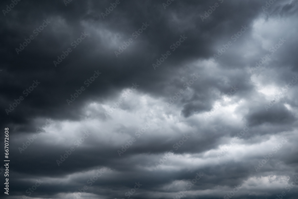 Obraz premium dark clouds make sky in black. Heavy rain thunderstorm. Pattern of clouds overcast predict tornado, Hurricane or thunderstorm and rainy. Dark sky cloudy have storm and lightning thunderbolt.