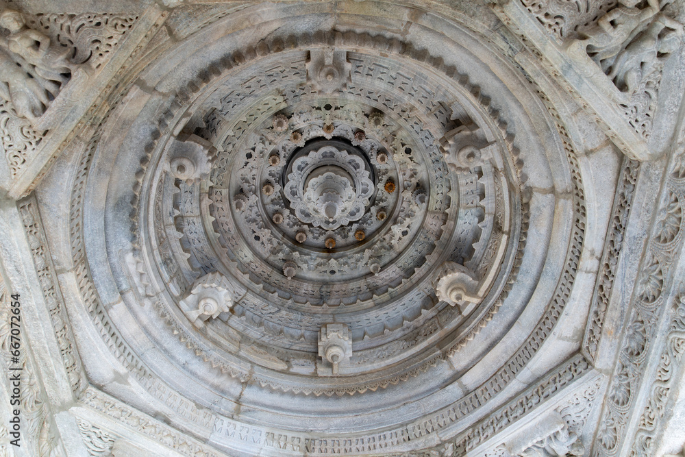 The interior is stunning, with unique carvings on the ceiling and columns. Marble carving decoration at the Jain temple in Ranakpur, Rajasthan, India.
