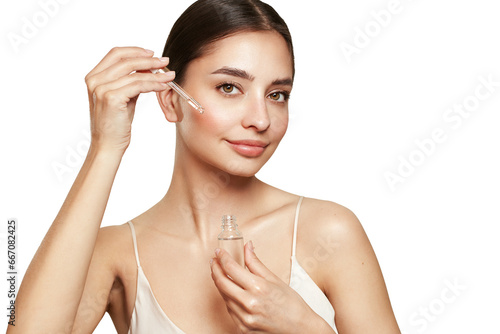 Wallpaper Mural Beautiful elegant woman holding a cosmetic jar of oil serum or hyaluronic acid in her hand. Perfect facial skin Torontodigital.ca