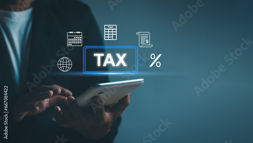 concept of government taxes and calculation of tax returns Personal income tax. man using tablet Fill out income taxes online using internet technology on application with State tax payment form photo