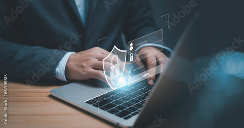 Businessman using laptop computer with virtual login system screen for identity and input access password ,technology security system and prevent hacker concept.
