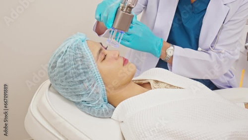 Doctor using CO2 Laser to treat skin conditions of patient.  Innovative dermatological procedure for skin rejuvenation and therapy. Aesthetics Skin Care Concept