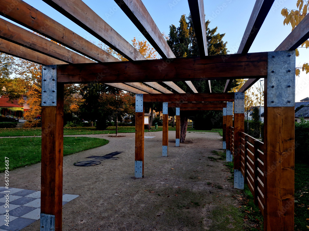 wooden construction of the bus stop, shelter of a gazebo pergola. the roof and walls are lined with polycarbonate plexiglass glass is anchored with stainless steel connectors. ceiling glass is visor
