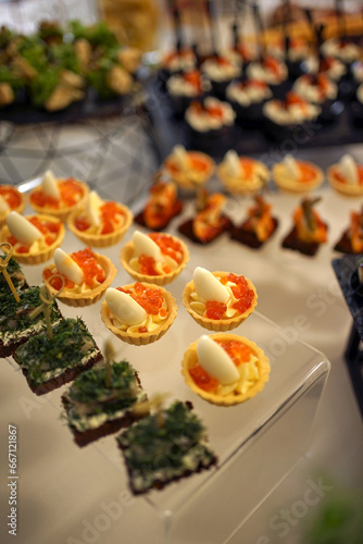 Buffet table with sandwiches with cheese  caviar and eggs.