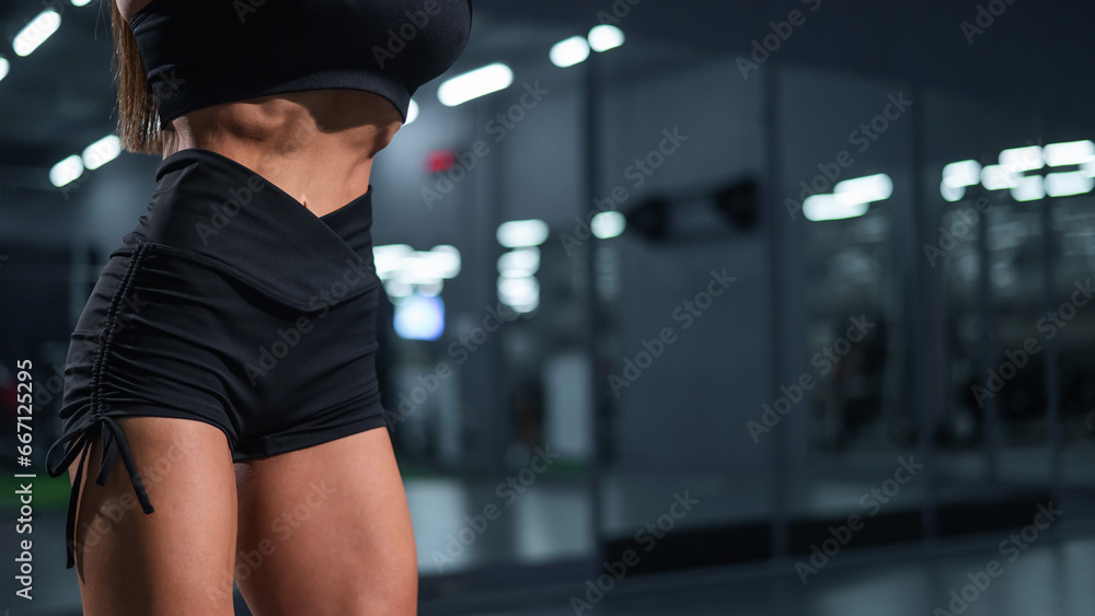 Fototapeta premium Faceless woman doing vacuum exercise in the gym. 