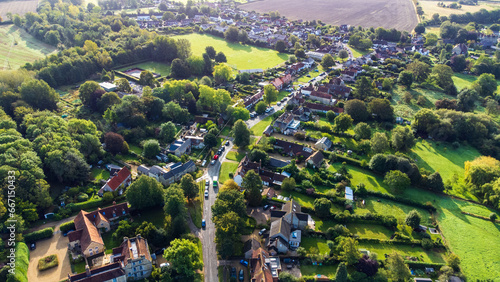 Scenic view of a small village in near Oxford. Homes lined up following the main road. Bright morning sun lights the area up with a glow.