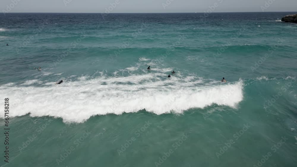 Aerial view surfers waiting for the perfect wave. Slow motion 4K Aerial view surfers waiting for the perfect wave. Slow motion 4K