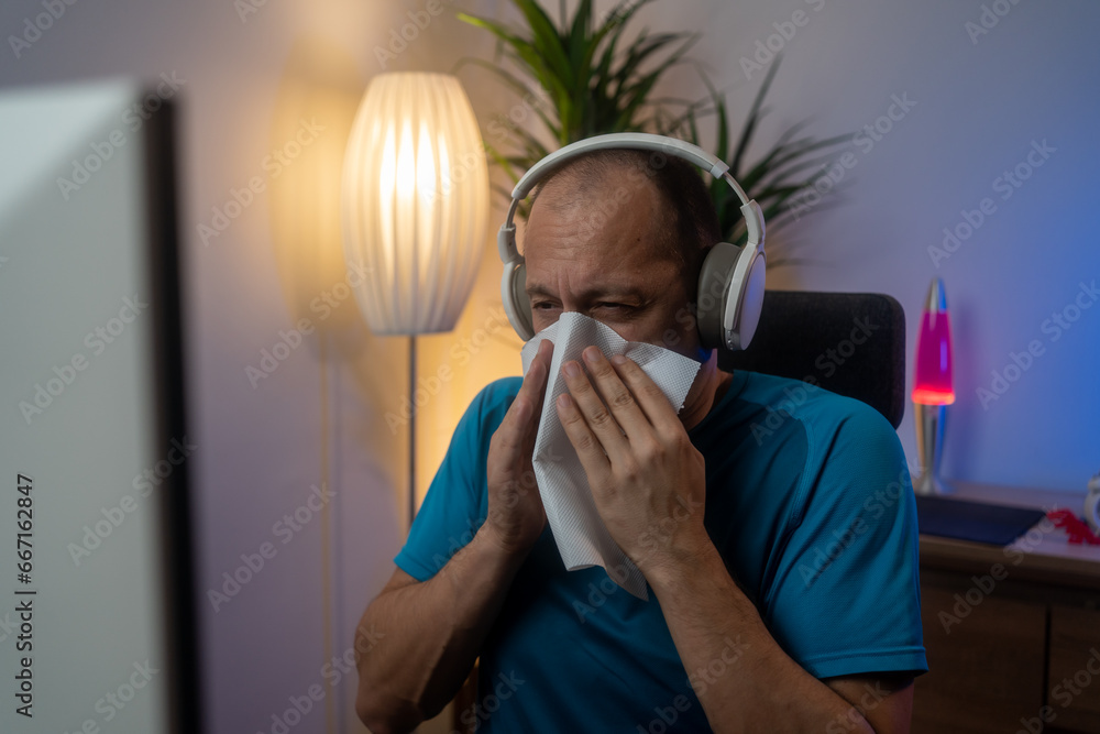Sick, allergy and blowing nose with man in home office for flu illness, hay fever and sneeze. Allergies, virus and sinus with employee and sneezing with tissue for influenza, cold and healthcare - obrazy, fototapety, plakaty 