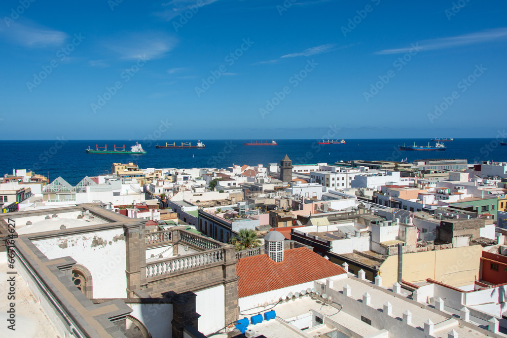 Obraz premium Town with part of the Santa Ana Cathedral, sea and freighter in Las Palmas on Gran Canaria, Spain