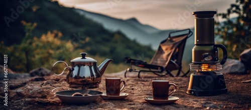 Camping trip with coffee set manual equipment bonfire and hiking in nature near mountains