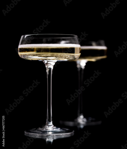 Two champagne glasses on a black