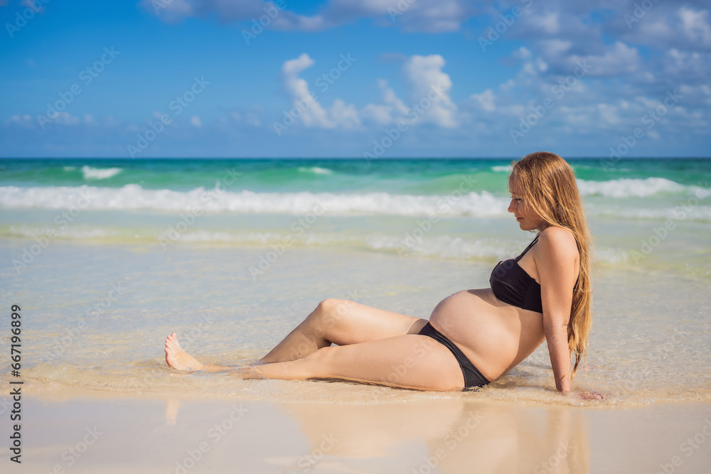 Radiant pregnant woman in a swimsuit, amid the stunning backdrop of a turquoise sea. Serene beauty of maternity by the shore Radiant pregnant woman in a swimsuit, amid the stunning backdrop of a turquoise sea. Serene beauty of maternity by the shore