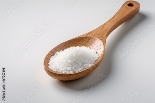 Crystals of large sea salt in a wooden spoon. Minimalist photography.