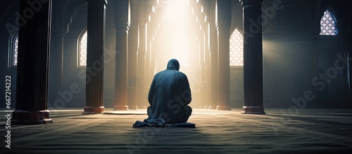 Devout Muslim praying indoors in a mosque photo