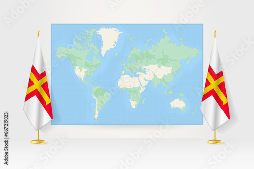 World Map between two hanging flags of Guernsey flag stand.