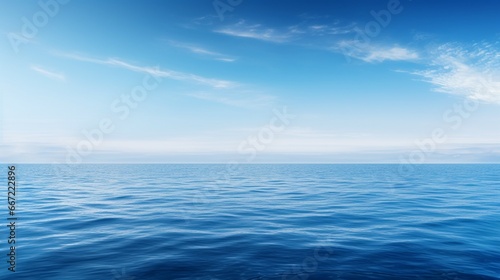 A view of a calm ocean, endless horizon stretching out, the stillness of the deep blue.