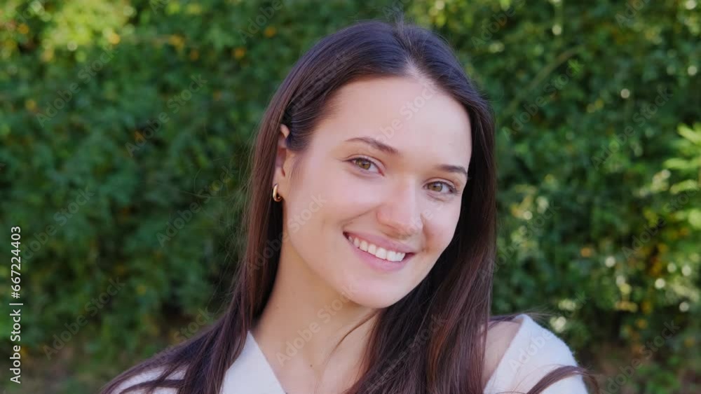 Closeup face of beautiful brunette sexy smiling woman with long hair. Portrait of gorgeous girl looking to camera Closeup face of beautiful brunette sexy smiling woman with long hair. Portrait of gorgeous girl looking to camera