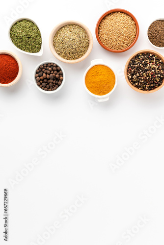 Overhead shot of seasonings in bowls isolated on white background with copyspace