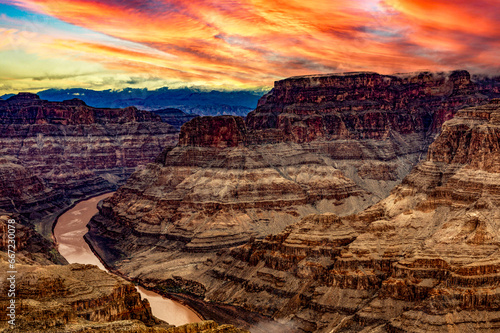 Views of the Guano viewpoint in the Grand Canyon National Park of Colorado, in the state of Arizona in the USA, with privileged views of the river and an orange sky at sunset.