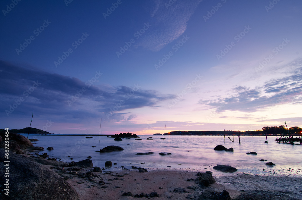 Beautiful seascape with colorful sky. Sunset and night time on the rock beach.