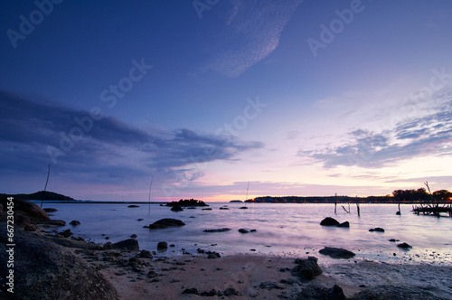 Beautiful seascape with colorful sky. Sunset and night time on the rock beach.