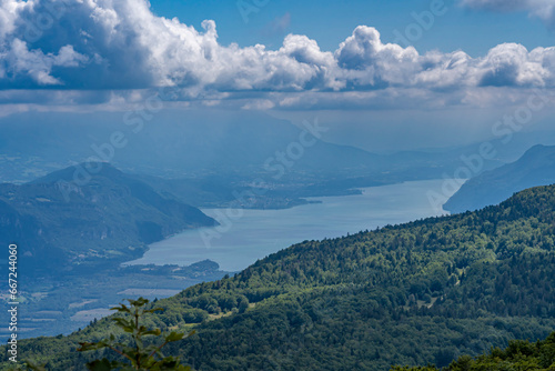 Grand Colombier, France - 08 31 2021: Grand Colombier Pass. View of the forest, the road, the Rhone river, the mountains ridge and Lake Bourget behind. © Franck Legros