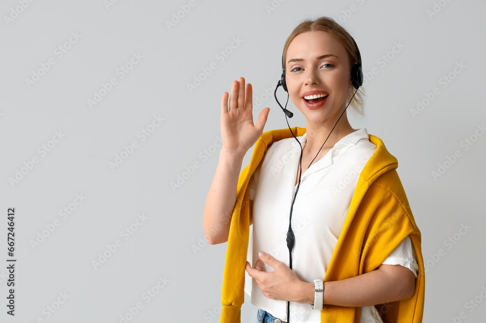 Female technical support agent  on light background
