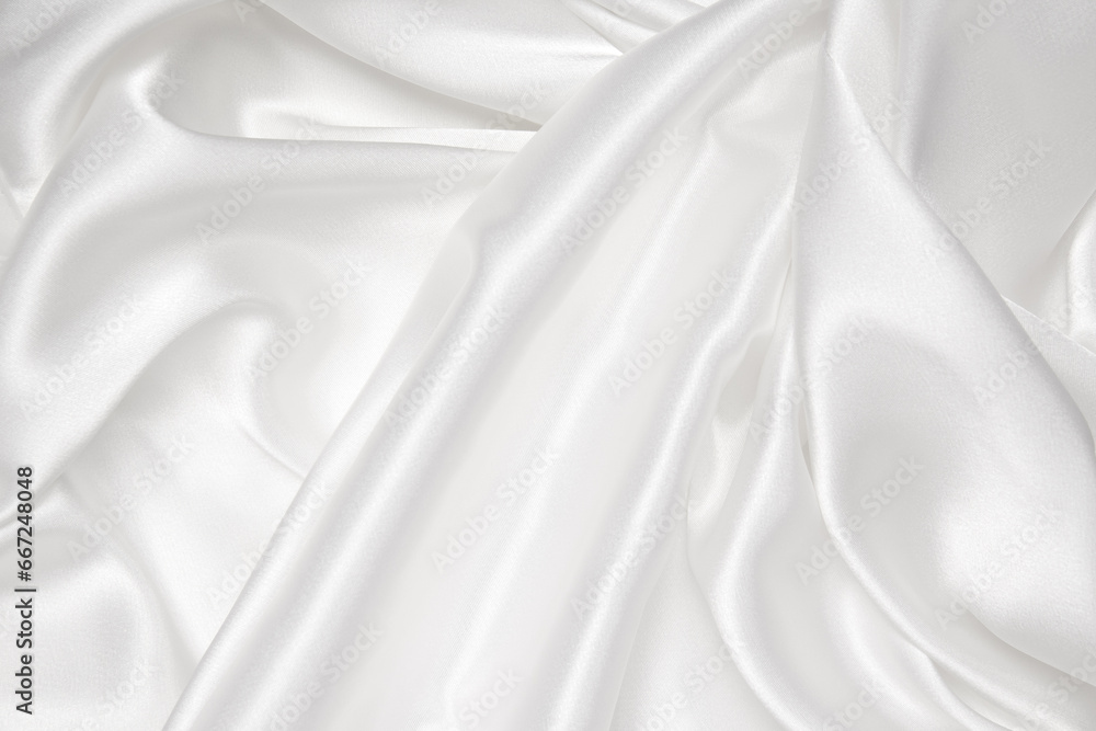 Obraz premium Abstract white fabric texture background. Cloth soft wave. Creases of satin, silk, and cotton.
