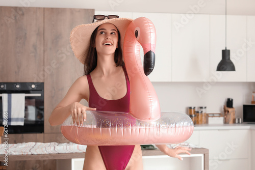 Young woman with swim ring ...