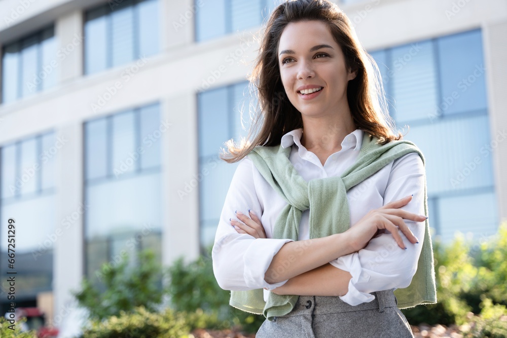 Fototapeta premium Businesswoman portrait. Caucasian female business person standing outdoor looking at camera