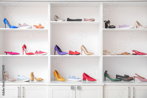 Shelves with different female shoes in boutique