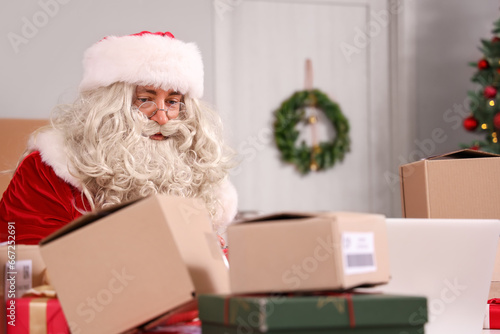 Santa claus working on lapt...