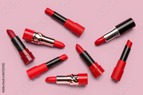Different new bright lipsticks on pink background