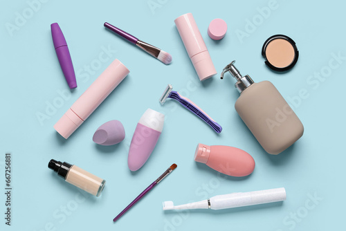 Composition with cosmetic products and bath accessories on blue background