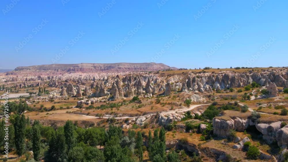 In this mesmerizing aerial stock video, we traverse Love Valley, Cappadocia, Turkey, where nature's artistry has carved a surreal landscape of distinct-shaped rocks. These unique formations, shaped by In this mesmerizing aerial stock video, we traverse Love Valley, Cappadocia, Turkey, where nature's artistry has carved a surreal landscape of distinct-shaped rocks. These unique formations, shaped by